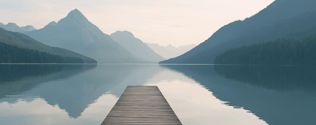 Wooden pier leading across a calm mountain lake – symbolizing guidance and direction through Executive Interim Management with NextShift Leadership.